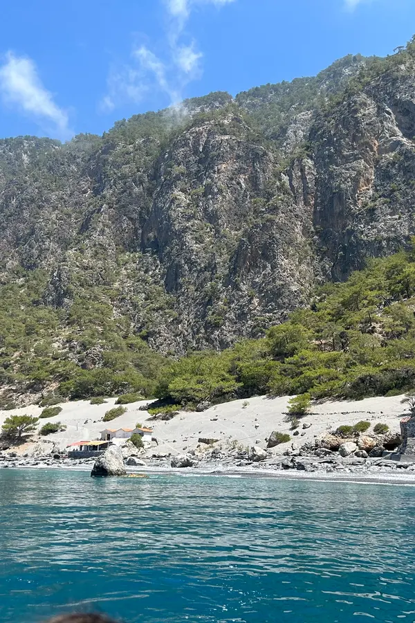 Calm waters and pebble beach at Agios Pavlos bay, offering beautiful views of the Cretan coastline.